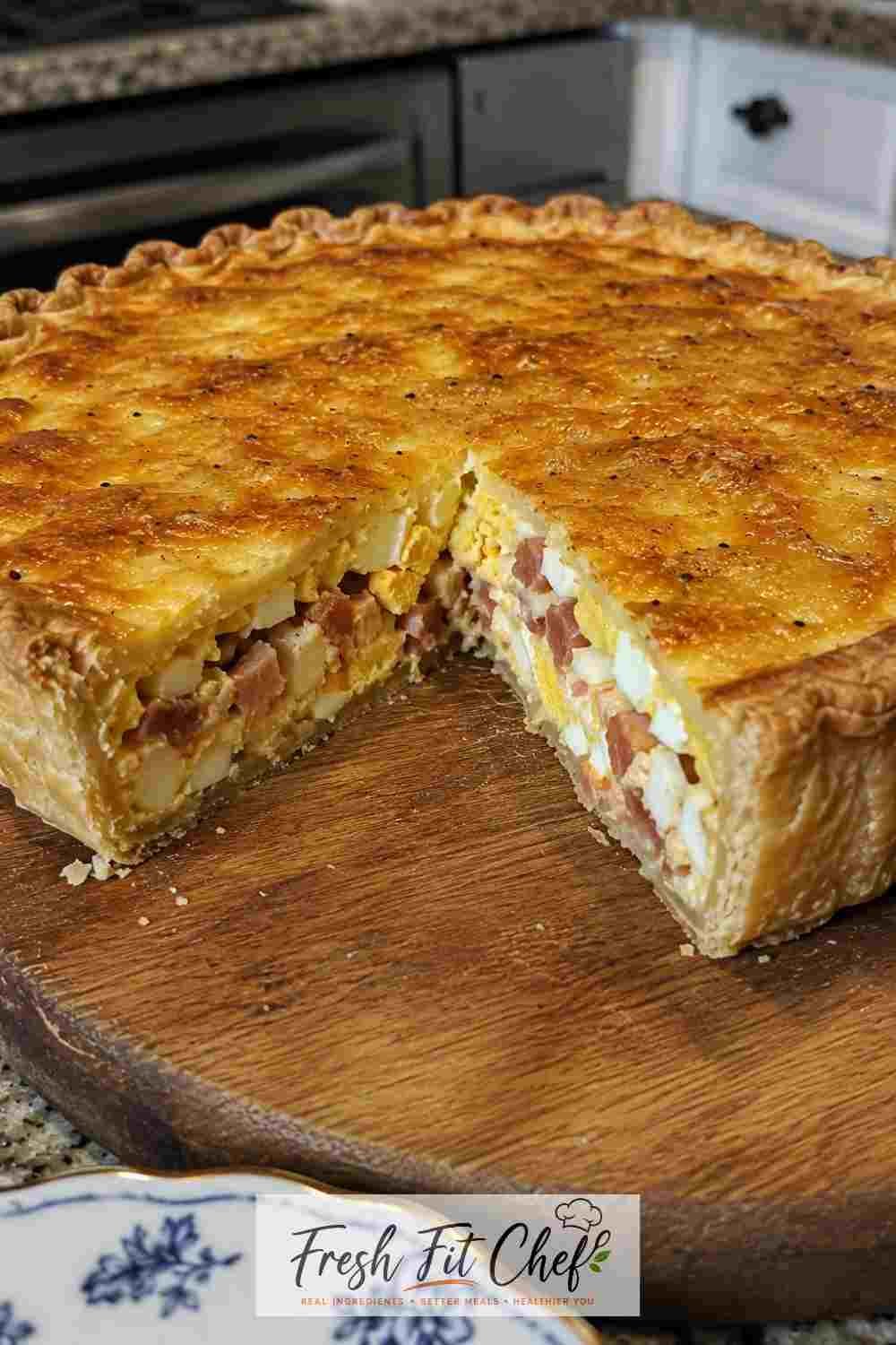Freshly baked crisp golden Delia Smith style bacon and egg pie sliced on a plate